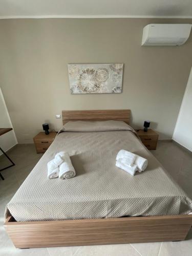 a bedroom with a bed with two towels on it at L'Uliveto B&B in Castelnuovo Cilento