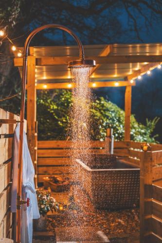 a water fountain in front of a gazebo at The Hideaway at Tregoose Old Mill in Newquay