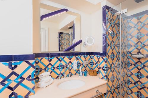 a bathroom with a sink and a mirror at Five Positano in Positano