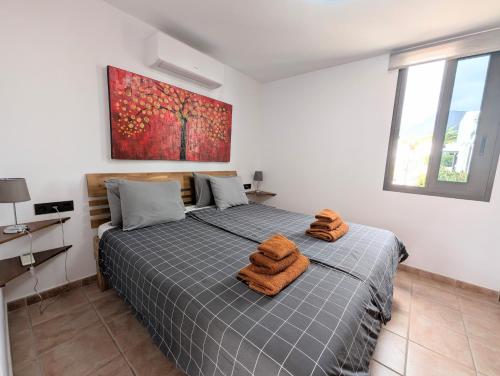 a bedroom with a bed with two towels on it at Luxury & Panorama Apartment in Costa de Adeje