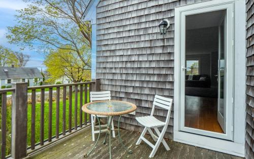 a patio with a table and chairs on a porch at Open Concept Beach House in Middletown