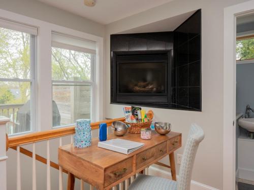 a dining room with a wooden table and a television at Open Concept Beach House in Middletown