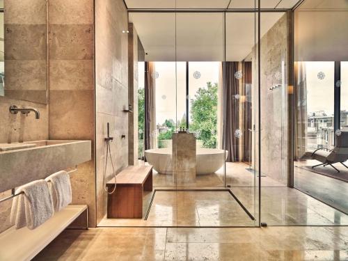 a bathroom with a tub and a sink at Conservatorium Hotel in Amsterdam