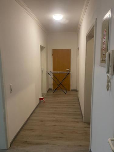 a hallway of an office with a table and a hallway at Mano 2 in Stuttgart