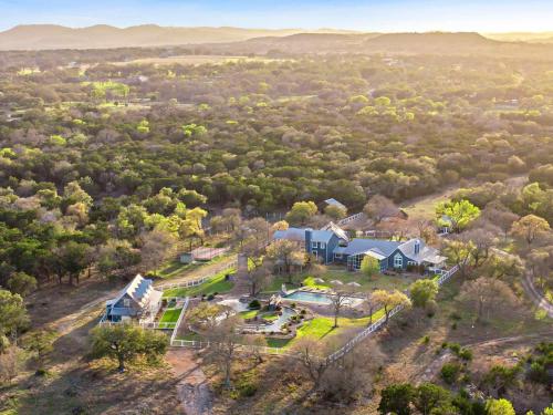 an aerial view of a large house in a field at Lazy River Ranch - Lazy River Pool, Golf & Pickleball in Kreutzberg