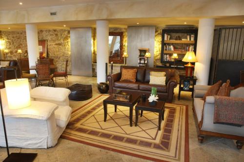 a living room filled with furniture and a large window at Solar do Castelo - Lisbon Heritage Collection - Alfama in Lisbon