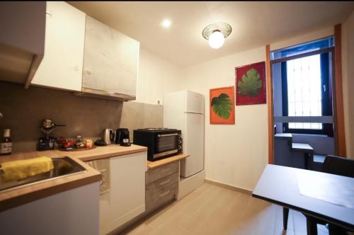 a small kitchen with a sink and a microwave at Home4U Κερατέα apt5, just 17Km from airport in Keratea