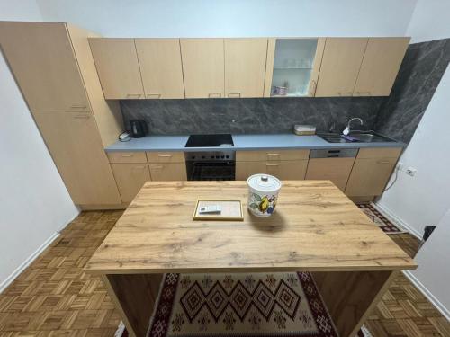 a kitchen with a wooden table with a mug on it at Old Town Heritage in Gradačac