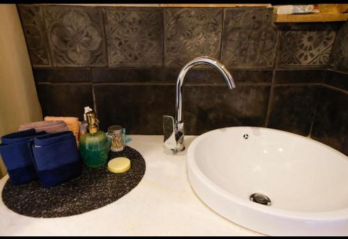 a bathroom counter with a sink and a faucet at Home4U Κερατέα apt5, just 17Km from airport in Keratea