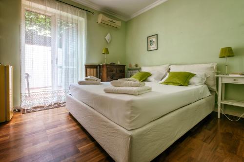 a large white bed in a room with a window at Alden in Formia