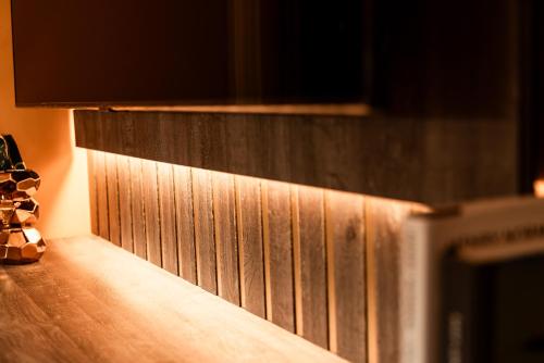 a wooden counter top with a wooden wall at Domo Boutique Hotel Birmingham in Birmingham