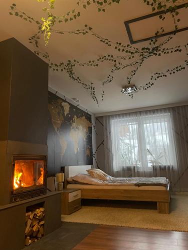 a bedroom with a bed and a fireplace at Dom w górach z kominkiem i balią ogrodową Sielanka in Skomielna Czarna