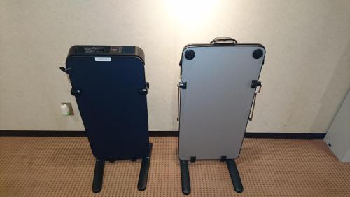 twozers are standing next to each other in a room at Hotel Sunroute Goshogawara in Goshogawara