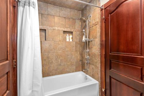 a bathroom with a shower and a white bath tub at Douglas Retreat in Douglas