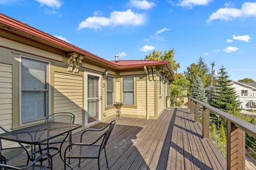 a wooden deck with a table and chairs on a house at Douglas Retreat in Douglas