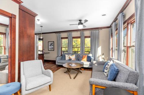 a living room with a couch and chairs and windows at Douglas Retreat in Douglas