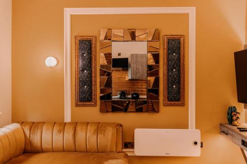 a living room with a couch and a painting on the wall at Domo Boutique Hotel Birmingham in Birmingham