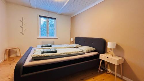 a bedroom with a bed in a room with a window at Wildlandia Älg Ferienhaus in Hagfors