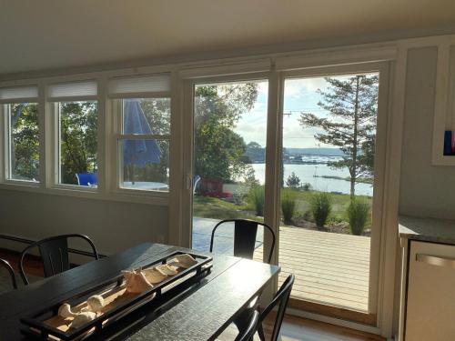 a dining room with a table and a large window at Mystic Magical Sunsets awaits your arrival in Mystic