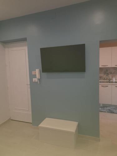 a white wall with a flat screen tv on a wall at La Terrazza di Porticello in Porticello