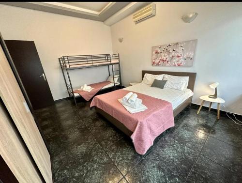 a bedroom with a bed and a bunk bed at Sand Blue Nea Peramos in Néa Péramos