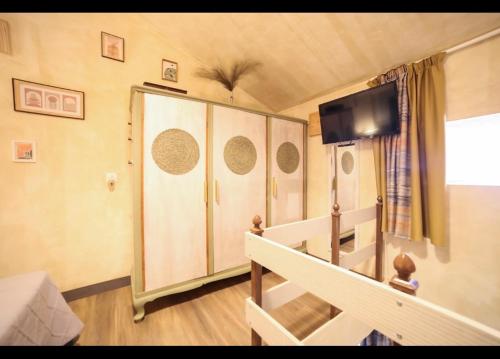a small room with a bed and a sliding door at Home4U Κερατέα apt4, just 17km from airport in Keratea