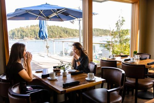two women sitting at a table in a restaurant at Friday Harbor House in Friday Harbor