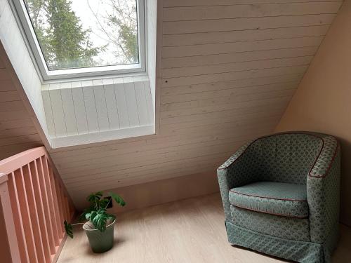 a chair in a room with a window at Stallet in Ystad