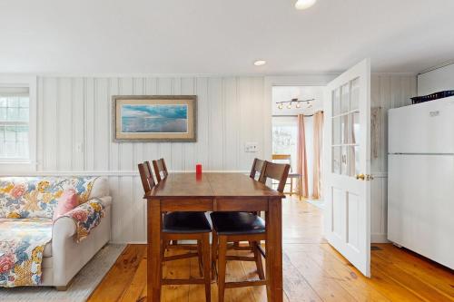 a kitchen with a table and chairs and a couch at Lucky Number Seven in Chatham