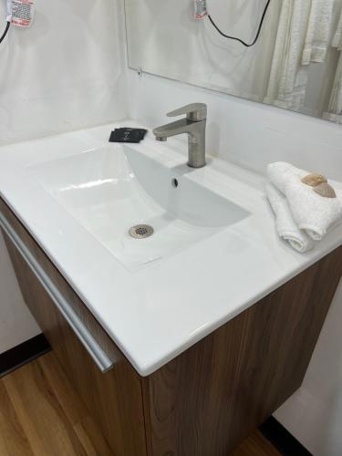 a bathroom with a white sink and a mirror at Flamingo Inn Beachfront - Daytona Beach in Daytona Beach