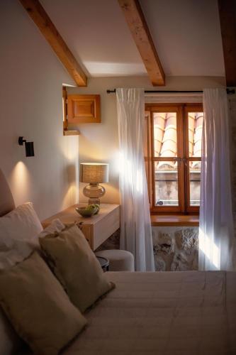 a bedroom with a bed and a desk and a window at Old Town Olive luxury room for 3 in Dubrovnik