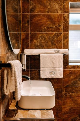 a bathroom with a sink and a mirror at Domo Boutique Hotel Birmingham in Birmingham