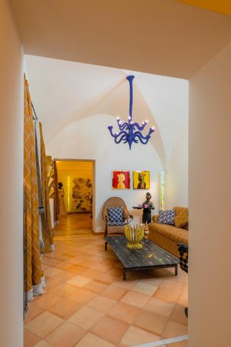a living room with a couch and a chandelier at Five Positano in Positano