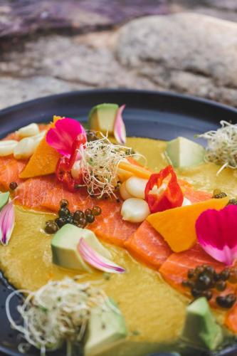 a plate of food with fruit and vegetables on it at Lizzy Wasi Urubamba in Urubamba