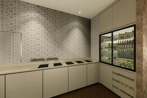 a kitchen with white cabinets and a window at Sheraton Grand Incheon Hotel in Incheon