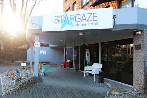 a building with a sign for a home hotel at Stargaze Home Hotel in Haan