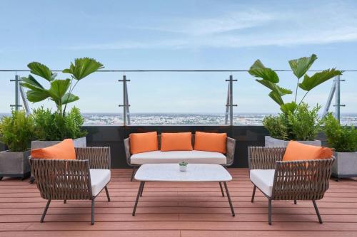 a patio with a couch and two chairs and a table at Sheraton Can Tho in Can Tho