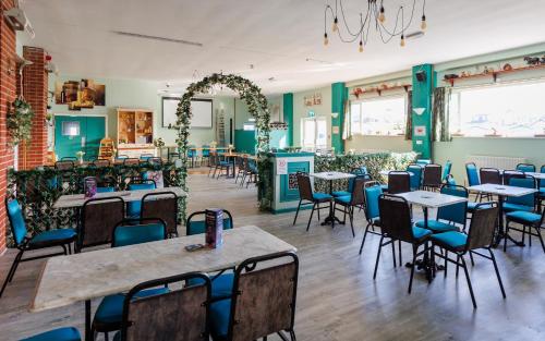 a dining room with tables and chairs in a room at Island Retreat in Sandown