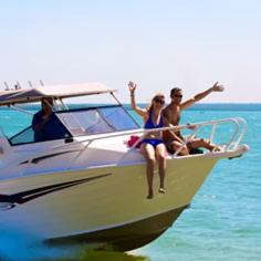 a group of people sitting on a boat in the water at Crab Claw Island in Bynoe Harbour