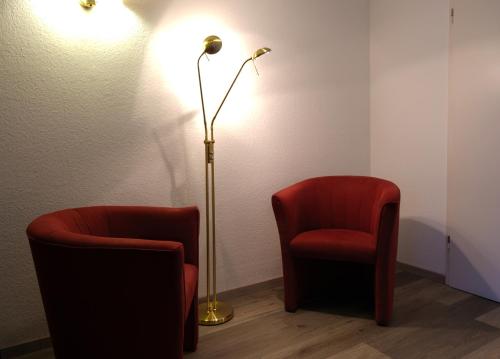 a room with two chairs and a floor lamp at Stargaze Home Hotel in Haan