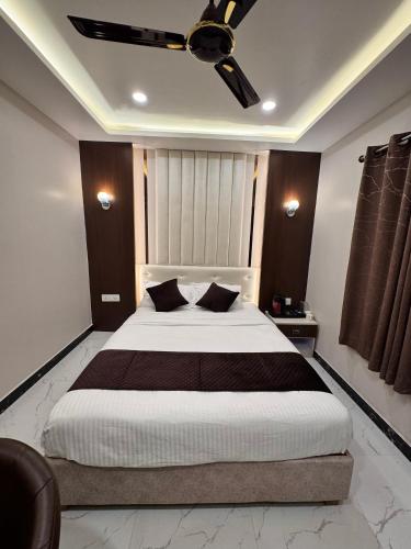 a bedroom with a large bed with a ceiling fan at Hotel Royal Mithila Private Limited in Janakpur