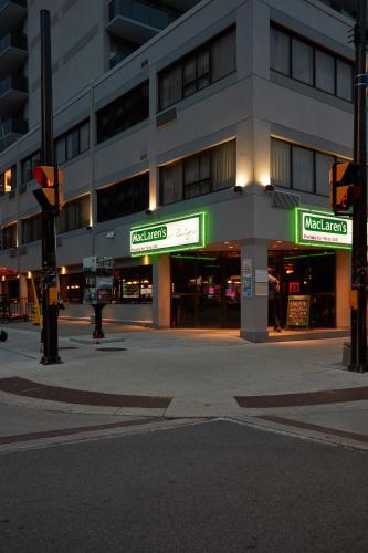 a building with neon signs on the side of a street at The Business Inn in Ottawa