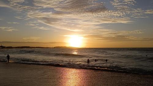 a group of people in the water at the beach at Apê da Mel in Galinhos
