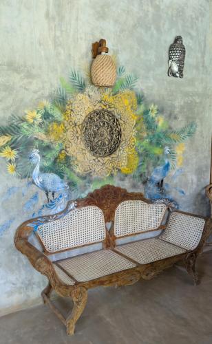a table with a painting on the wall at Hotelito Sri Lanka in Weligama