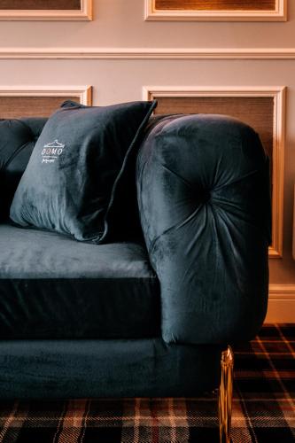 a black couch with a large pillow on it at Domo Boutique Hotel Birmingham in Birmingham