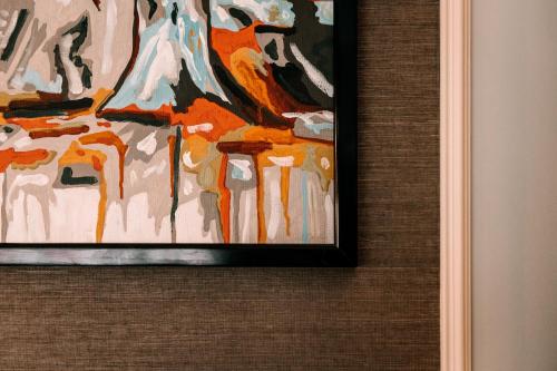 a painting is hanging on a wall at Domo Boutique Hotel Birmingham in Birmingham