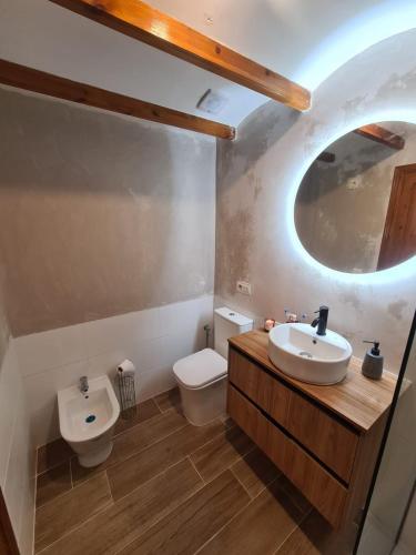 a bathroom with a sink and a toilet at Casa Blancos in Rojales