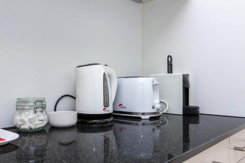 a kitchen with two coffee machines on a counter at KAYA Zurich Apartment 1B - Deluxe 2BR Downtown Apt in Zürich
