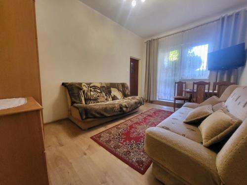 a living room with a couch and a chair at Błękit Bałtyku in Łazy