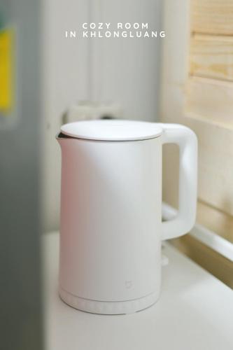 a white coffee cup sitting on a counter at Cozy room in Khlongluang - Self Check-in in Khlong Luang